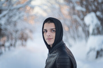 portrait of a young man with a hoodie outside