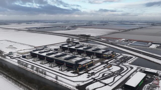 data center, computing center, hyperscaler, computer servers, cloud services, it services, aerial view. Building exterior in winter.