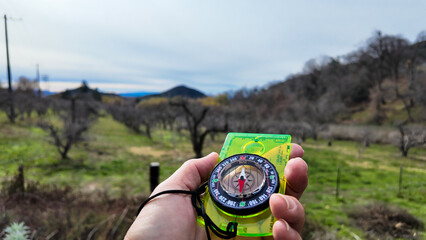 A Compass being used on the trail to find direction using the magnetic field of the earth with a...