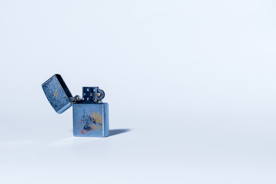 Open silver chrome Camel Zippo windproof lighter featuring artistic city sketch graphic on its body. Isolated on white background. Ukraine, Zhytomyr, January 04, 2026