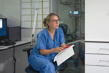 Female doctor thinking, analyzing patient data in hospital office
