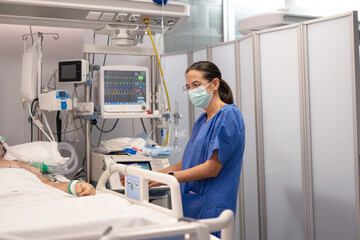 Nurse monitoring patient in intensive care unit