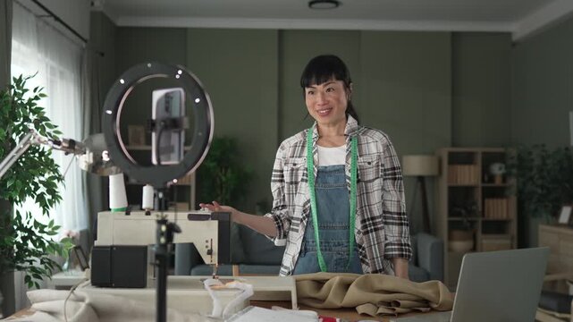 Asian dressmaker creating online video content for blogging