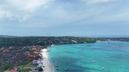 Aerial drone shot of island coastline with waves and blue sea