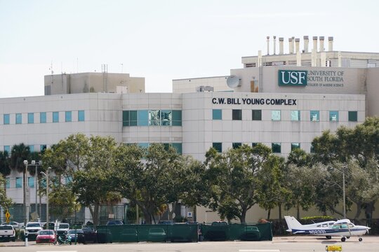 St Petersburg, Florida, U.S - Jan 3, 2026 - The C.W. Bill Young Complex at the University of South Florida College of Marine Science stands behind parked aircraft.