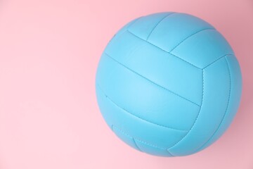 One volleyball ball on pink background, top view. Space for text