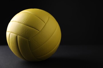 One volleyball ball on dark background, closeup. Space for text