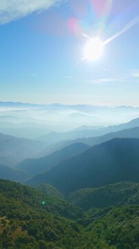 Aerial view of foggy mountain landscape and valley, Ceranesi, Italy, vertical video