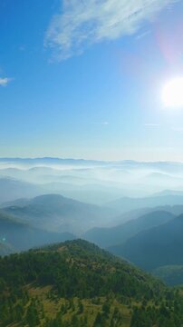 Scenic mountain valley with fog viewed from above, Ceranesi, Italy, vertical video