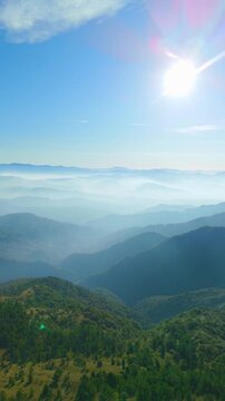 Aerial landscape view of foggy valley and mountains, Ceranesi, Italy, vertical video