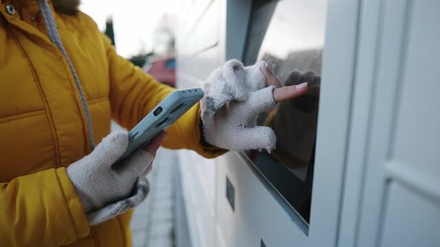 Girl Entering Code To Outdoor Automated Parcel Locker To Pick Up The Parcel