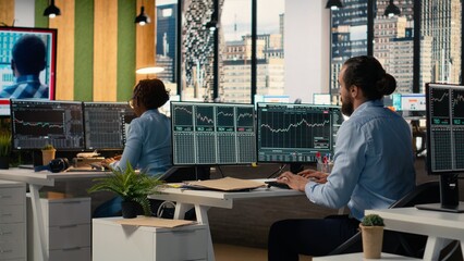 Traders in office follow TV coverage of Black Swan event shaking global finance, calling clients to...