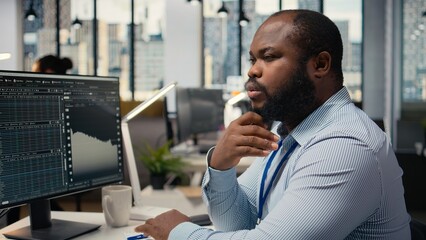 Close up of trader analyzing stock exchange analytics, doing thinking, evaluating trading strategy...