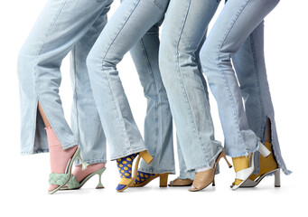 Female legs in jeans with stylish shoes and socks on white background