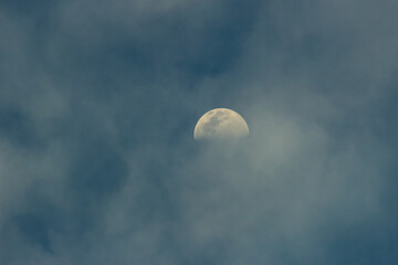 moon in blue sky with clouds