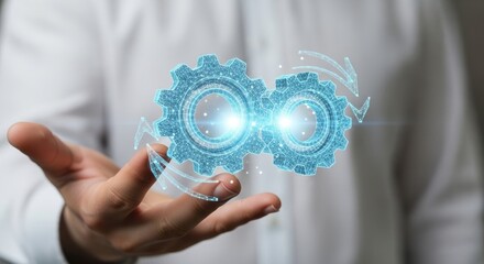 Close-up of a hand displaying luminous blue digital gears, representing technological advancement and interconnectedness.