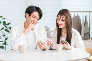 Couple having a conversation while drinking hot drinks at the dining table
