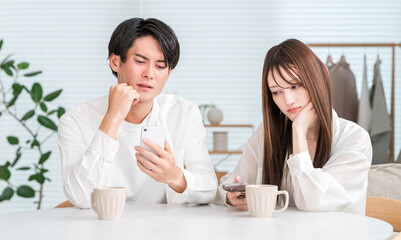 Couple having a conversation while drinking hot drinks at the dining table