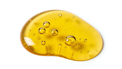 Macro close-up of golden liquid drop with bubbles on white background providing a fresh and clean
