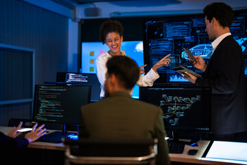 Automotive engineer presenting electric car design on large digital screen. Technical team analyzing vehicle aerodynamics and engine performance data in high-tech laboratory.