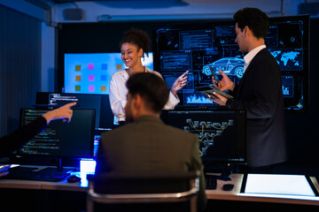 Automotive engineer presenting electric car design on large digital screen. Technical team analyzing vehicle aerodynamics and engine performance data in high-tech laboratory.
