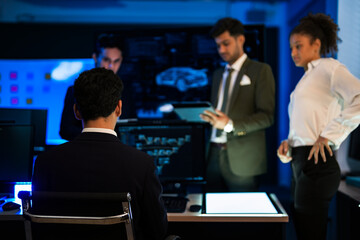 Automotive engineer presenting electric car design on large digital screen. Technical team analyzing vehicle aerodynamics and engine performance data in high-tech laboratory.
