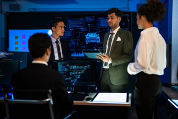 Industrial design team planning future transport strategy. Executive presenting new smart mobility concept and market trend analysis on digital board during late night workshop.