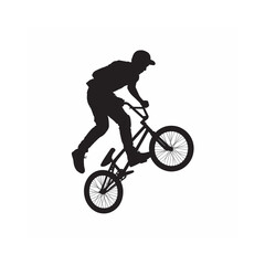 Fototapeta premium Silhouette of a biker performing a wheelie on a bmx bike dynamic action pose