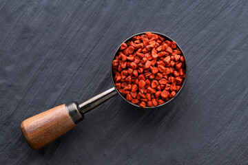 Bixa Orellana - Organic annatto red seeds in spoon