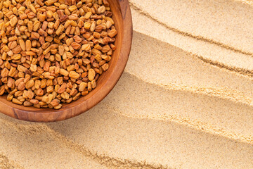Dried, organic fenugreek seeds in a bowl - Methi Dana