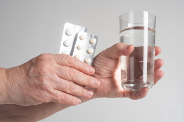 Medicine pills in holding hand for healthcare concept. Medicine in blister packaging for...