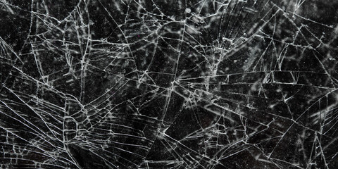 Obraz premium Cracked and shattered black glass screen background texture