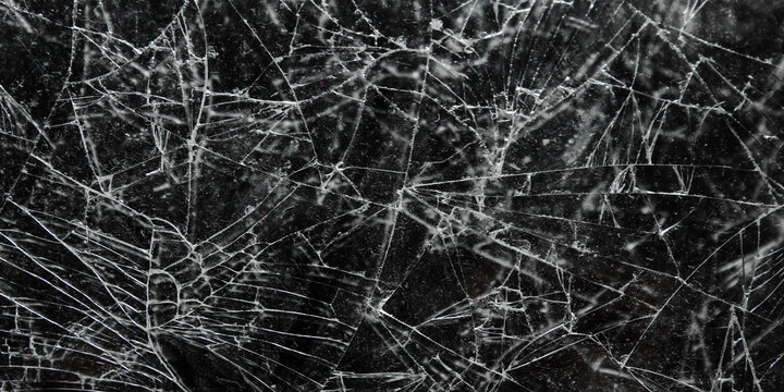 Cracked and shattered black glass screen background texture