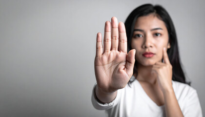 Young Asian Woman Making Stop Gesture With Hand Facing Camera On Gray Background