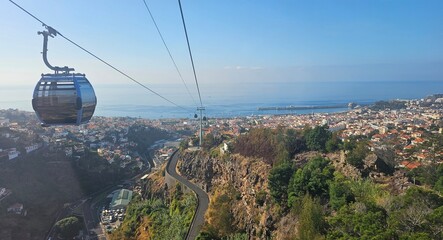 Aerial view of Funchal, Madeira Island, Portugal, featuring the cable car, cityscape, surrounding mountains, and the Atlantic Ocean. © Sebastiaan89