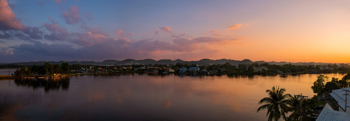 Scenic sunsets and colourful colonial architecture of historic center of Flores, Guatemala. View of lake Peten Itza, Flores Lake.
