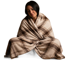 Woman wrapped in a beige and brown plaid blanket, smiling warmly isolated on transparent background
