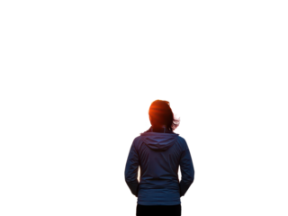 Silhouette of person standing at sunset with dramatic sky background isolated on transparent background
