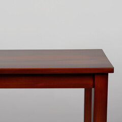 a rectangular rosewood table, against a white background