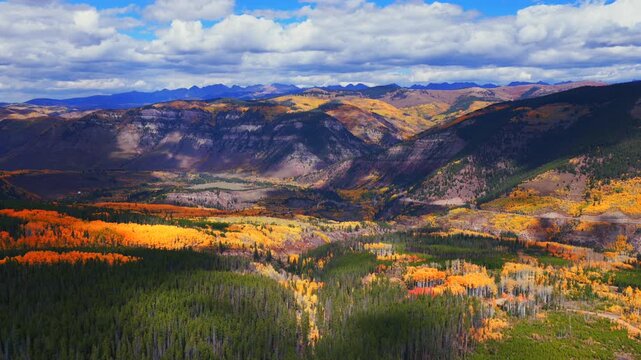 Minturn Red Cliff Vail Mount of the Holy Cross Wilderness Sawatch Gore Range aerial drone Fall Autumn sun cloudy morning Rocky Mountains Colorado colorful Aspen trees windy dirt road forward pan up