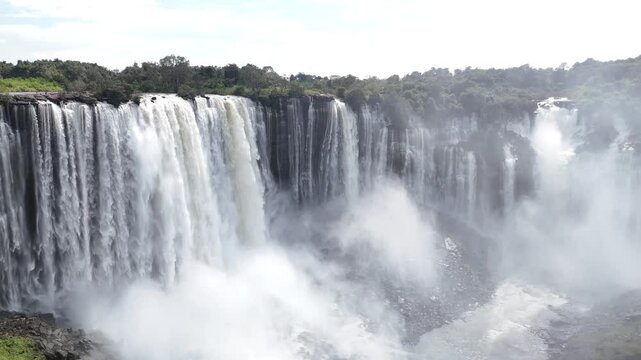 aerial drone birds-eye view of the massive white water cascades and rising mist at Calandula Falls, Malanje, Angola, Africa, a monumental natural landmark