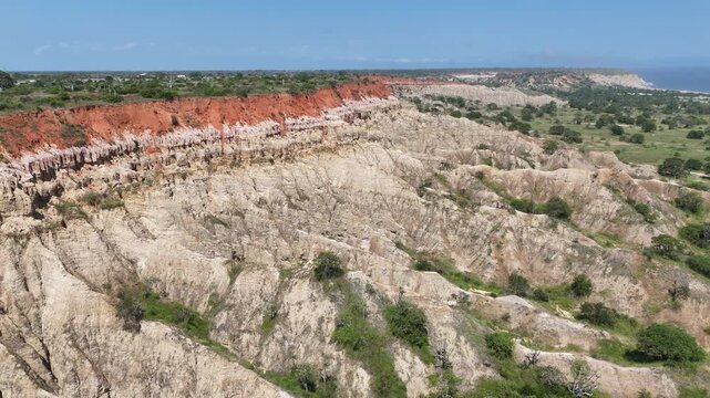 aerial drone of prehistoric geological textures of Miradouro da Lua, Belas, Luanda Province, Angola, Southern Africa, featuring vibrant red soil and deep gullies