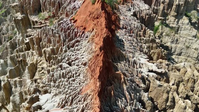 Stunning top-down perspective of the eroded lunar landscape at Miradouro da Lua, Luanda, Angola, Africa, highlighting the intricate orange and white soil textures