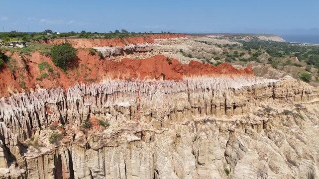 High-altitude perspective showing the dramatic erosion and unique topography of the Viewpoint of the Moon in Angola, red eroded cliffs at Miradouro da Lua, Africa drone aerial footage