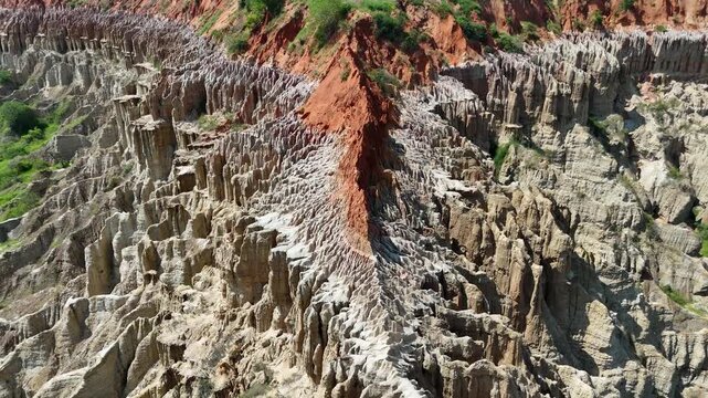 Dramatic aerial journey inside the deep clay gullies of Miradouro da Lua (Viewpoint of the Moon) in Belas Municipality, Luanda Province, Angola, Africa