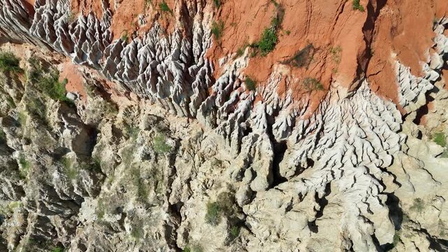 Cinematic drone footage of the stunning red clay cliffs at Miradouro da Lua (Viewpoint of the Moon) in Belas Municipality, Luanda Province, Angola, Africa