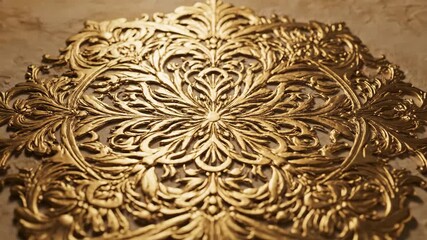 Ornate Golden Floral Design - A detailed close-up captures an elaborate golden floral design, showcasing intricate patterns and swirling lines.