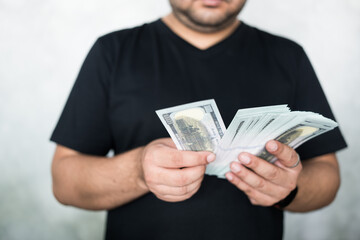 Man counting money, making savings, planning purchases, business, income.