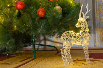 christmas reindeer with lights against the background of pine branches