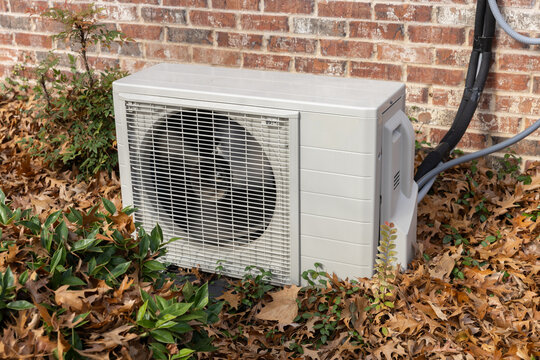 Air conditioning unit surrounded by fall leaves